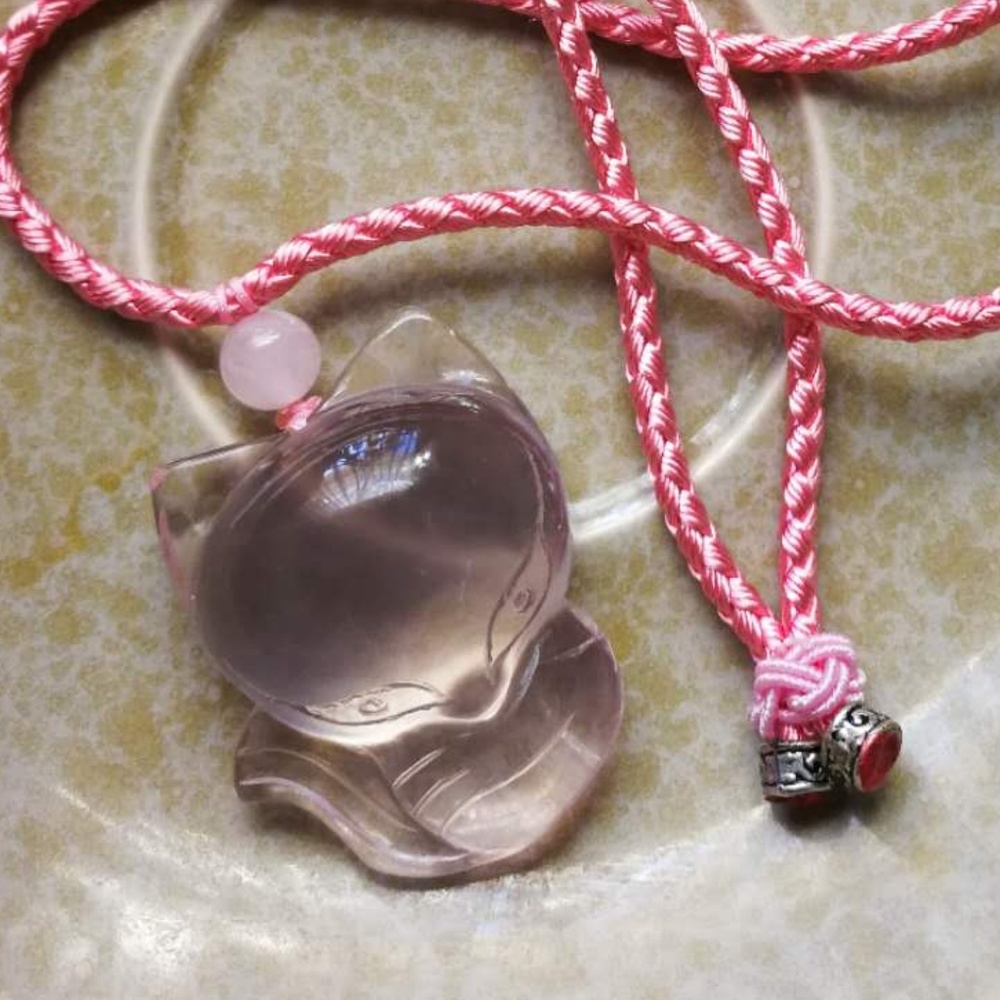 A cute pink quartz carved fox necklace